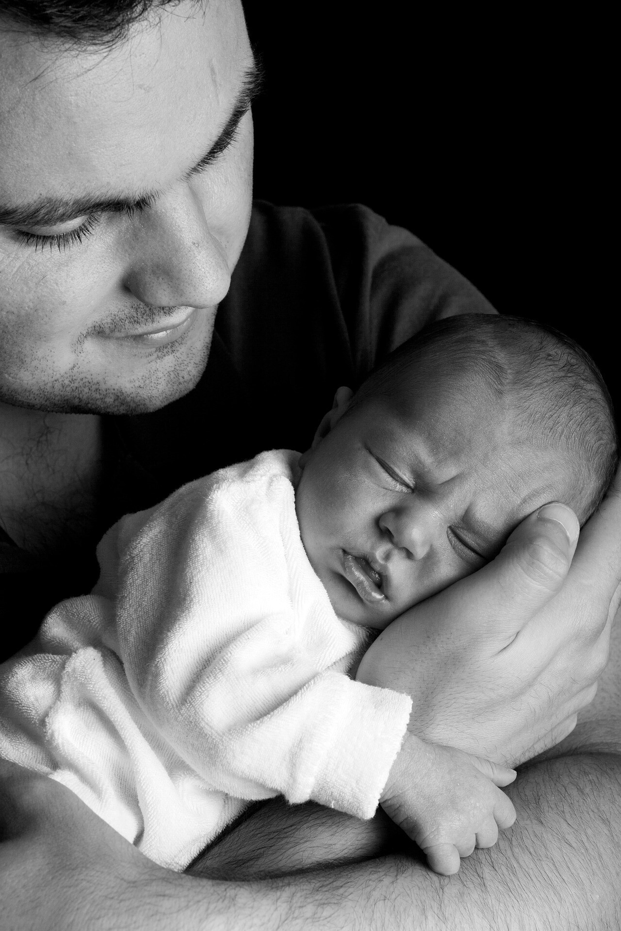 Baby held by his dad