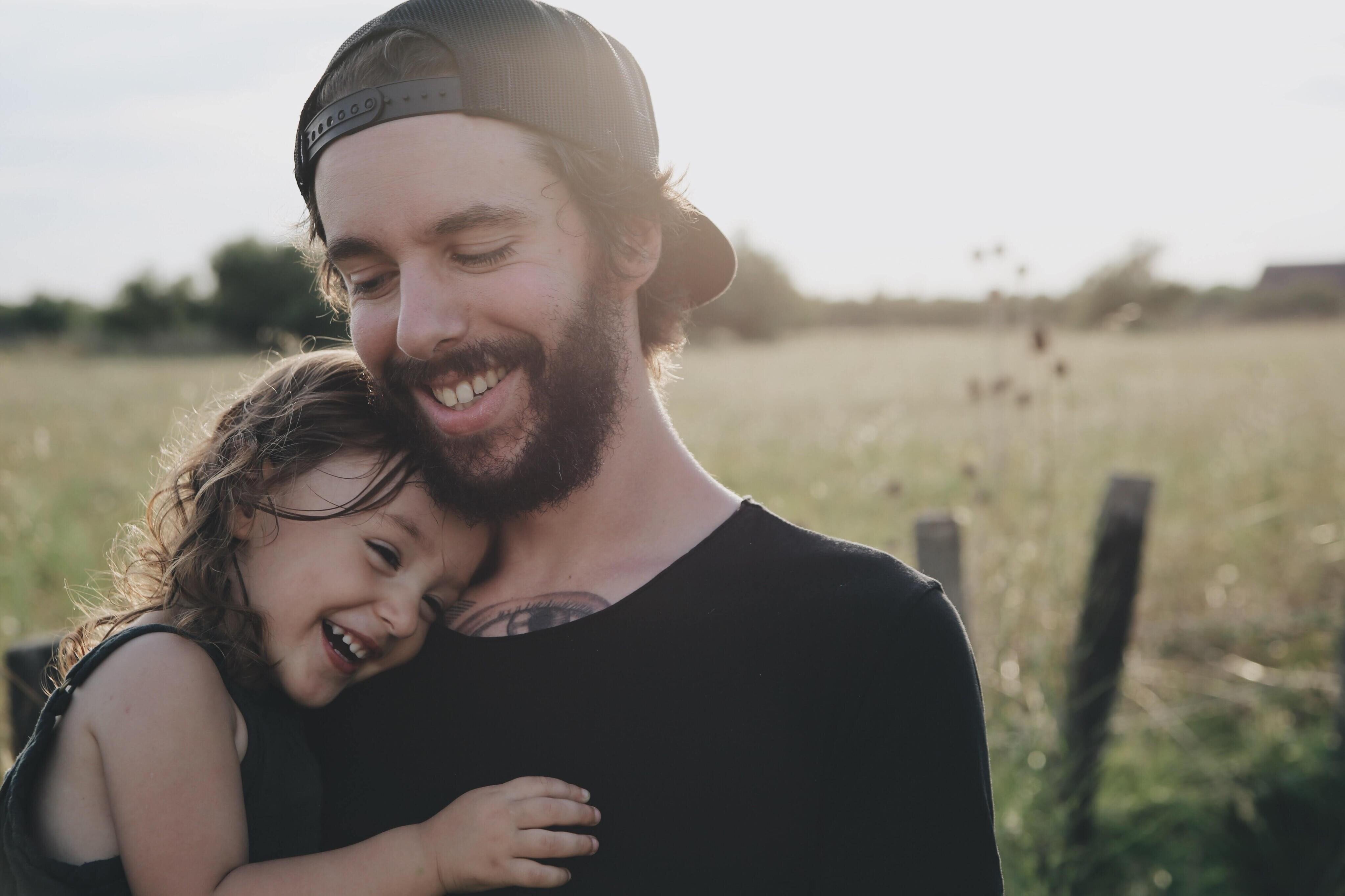 Dad with beard holding his young daughter